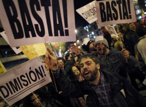 Protestors, pictured in Madrid last year, hold a demonstration against corruption in Spain.