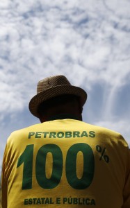 An oil industry worker wears a Brazilian soccer jersey that reads: "PETROBRAS 100% State-run and Public" during a protest at the Petrobras headquarters in Rio de Janeiro