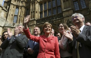 Scotland's First Minister and Scottish National Party leader Nicola Sturgeon waves as she poses with newly-elected SNP MPs in central London.